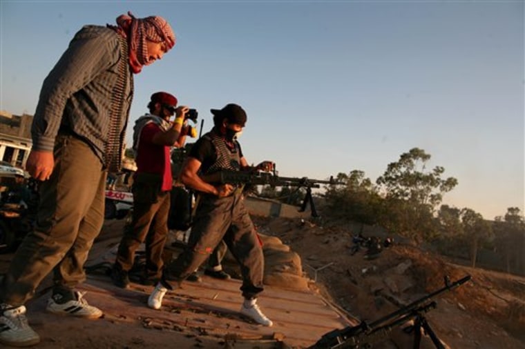 A Libyan rebel fighter fires a machine gun on the front line, west of Misrata, in Libya on May 28. The new rebel administration on Saturday warned it was fast running out of money because countries that promised financial aid have not come through.